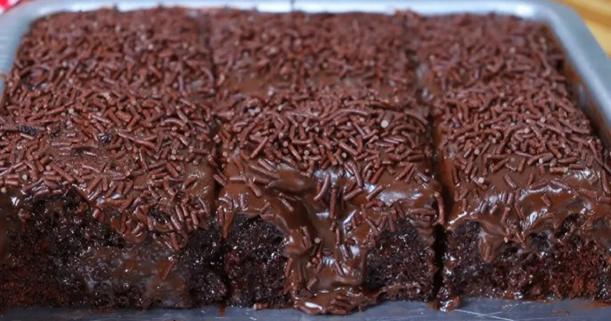 Esse bolo de chocolate é fácil, fofinho e vem com uma cobertura cremosa que faz qualquer pedaço desaparecer da mesa